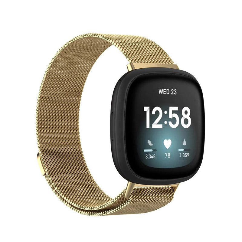 Gold milanese loop band smartwatch with black square face displaying time 12:58, heart rate, and step count metrics