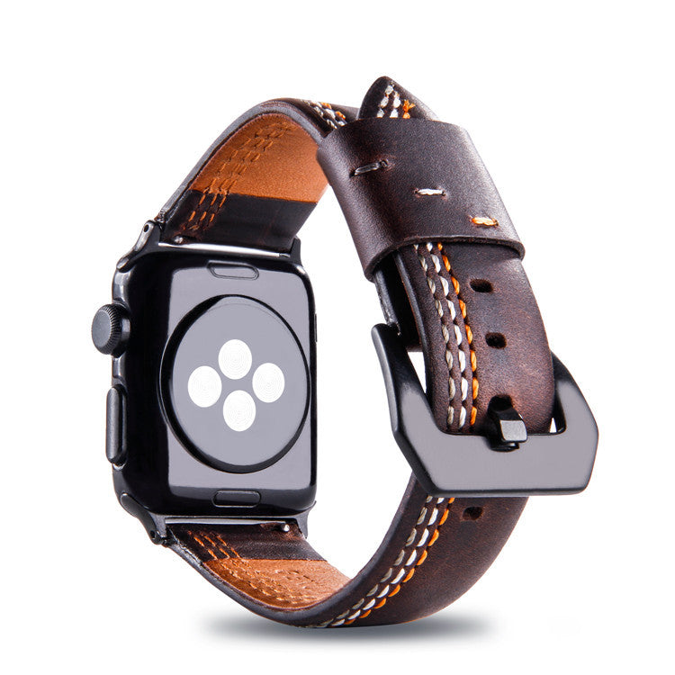 Dark brown leather Apple Watch band with asymmetrical white stitching and tan interior, shown on black smartwatch