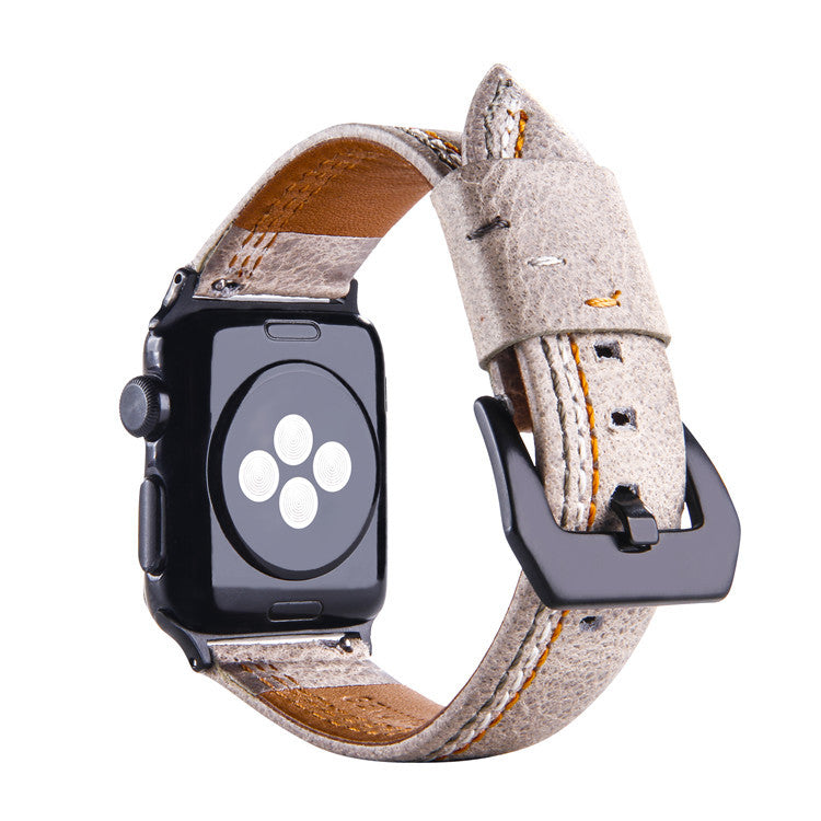 Ivory white wool Apple Watch band with asymmetrical stitching, brown leather backing, and black connector hardware