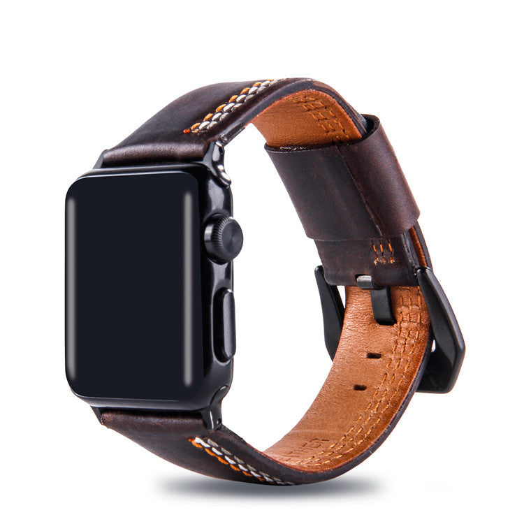 Dark brown leather smartwatch band with asymmetrical orange stitching, tan interior lining, and black connector hardware