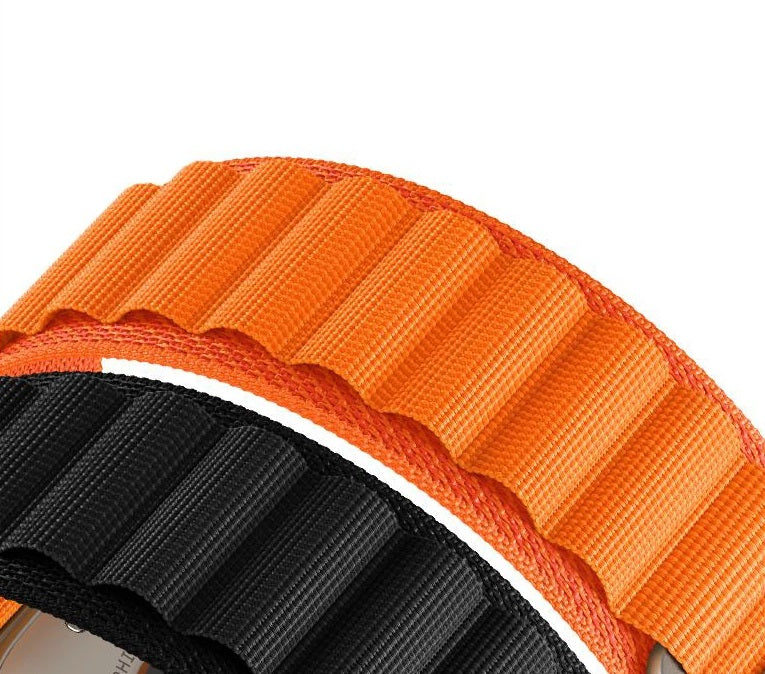 Orange and black woven Alpine Loop band for Galaxy Watch 4-7 with textured fabric close-up