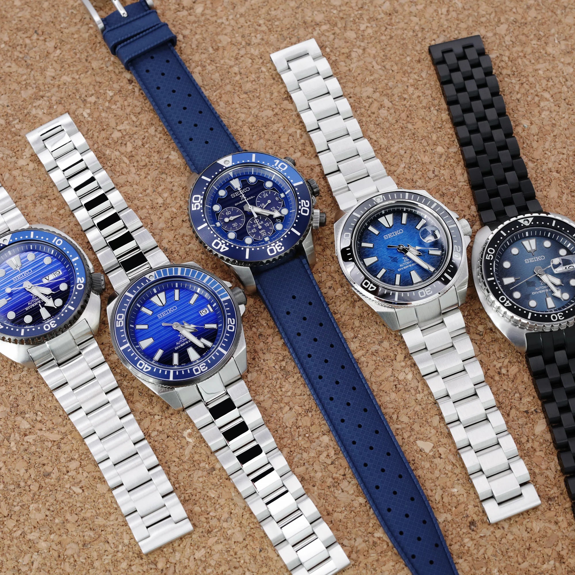Seiko Turtle dive watches with Super-O Boyer bracelets and blue rubber strap on cork background