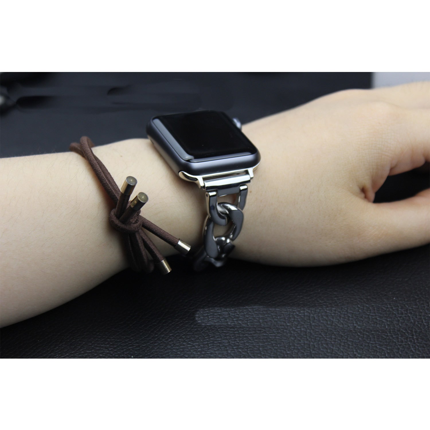 Apple Watch chain link bracelet in silver worn on wrist with smartwatch and brown fabric band