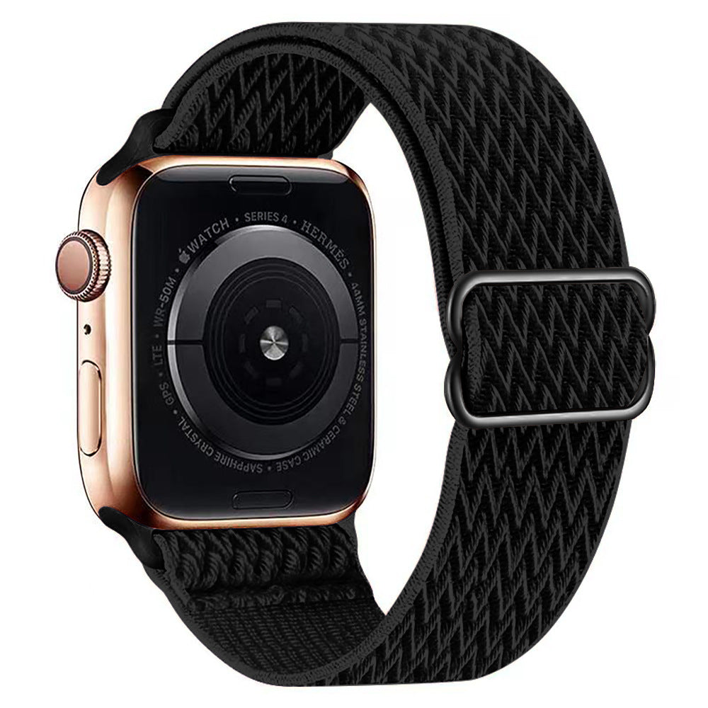 Gold stainless steel smartwatch with black woven fabric loop band and digital display showing series 4