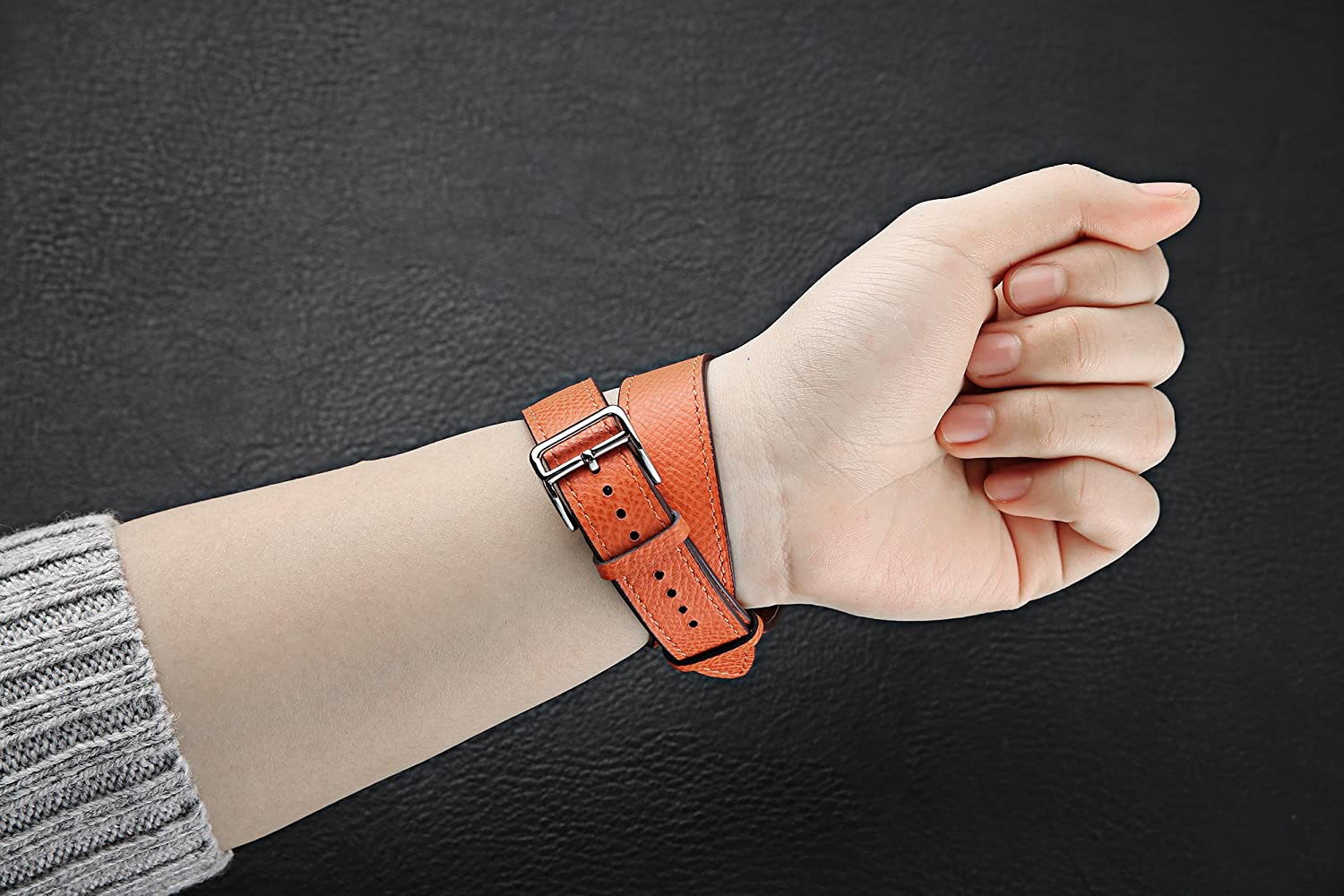 Orange leather double tour Apple Watch band with silver buckle on wrist