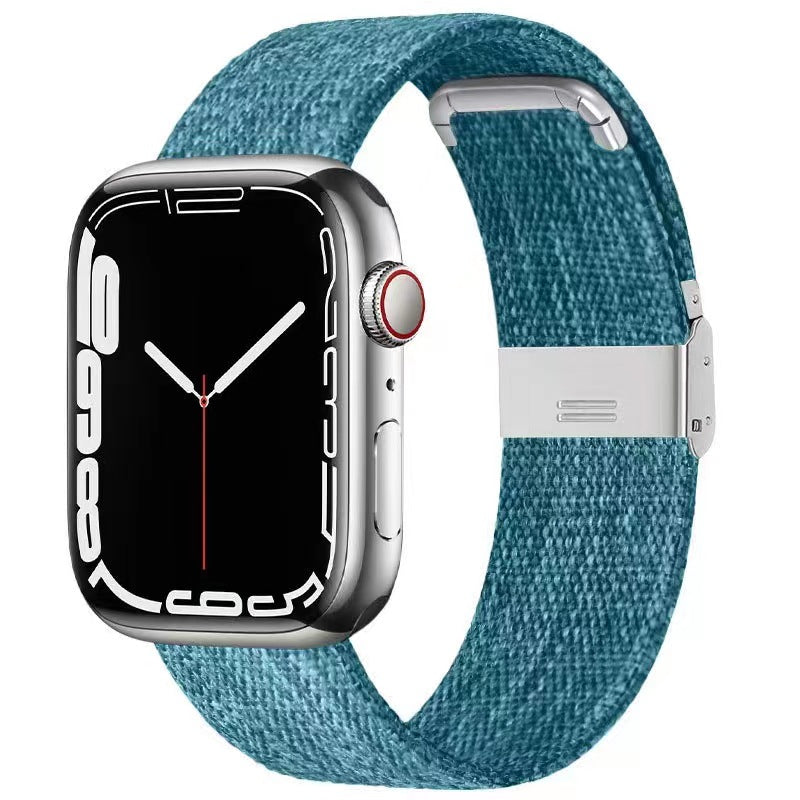 Silver stainless steel smartwatch with teal woven canvas band and magnetic clasp closure