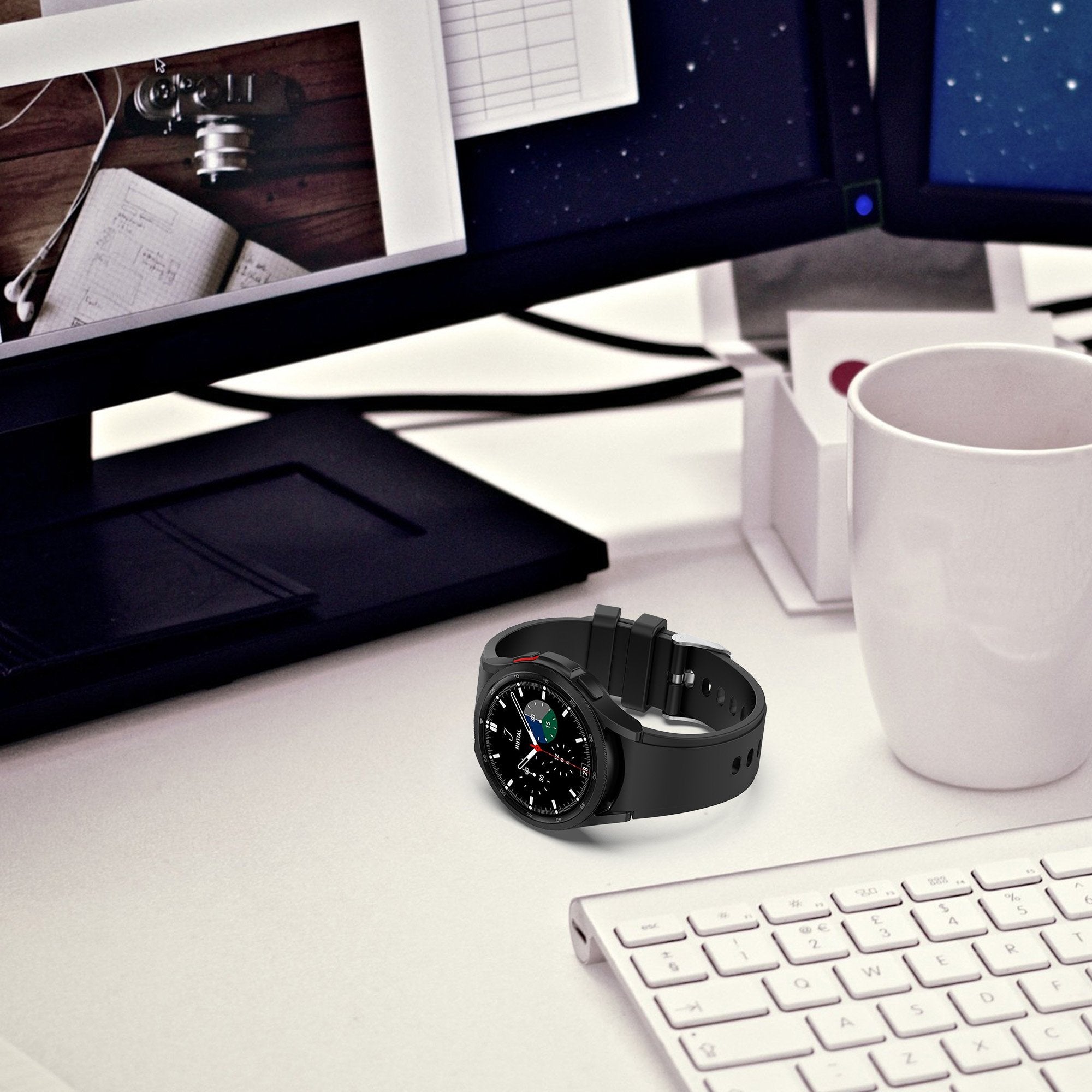 Black silicone smartwatch with sport band displayed on modern office desk next to keyboard and white mug