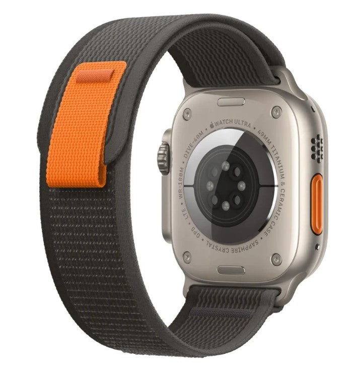 Apple Watch Ultra with gray and orange Trail Loop band featuring titanium case and digital crown