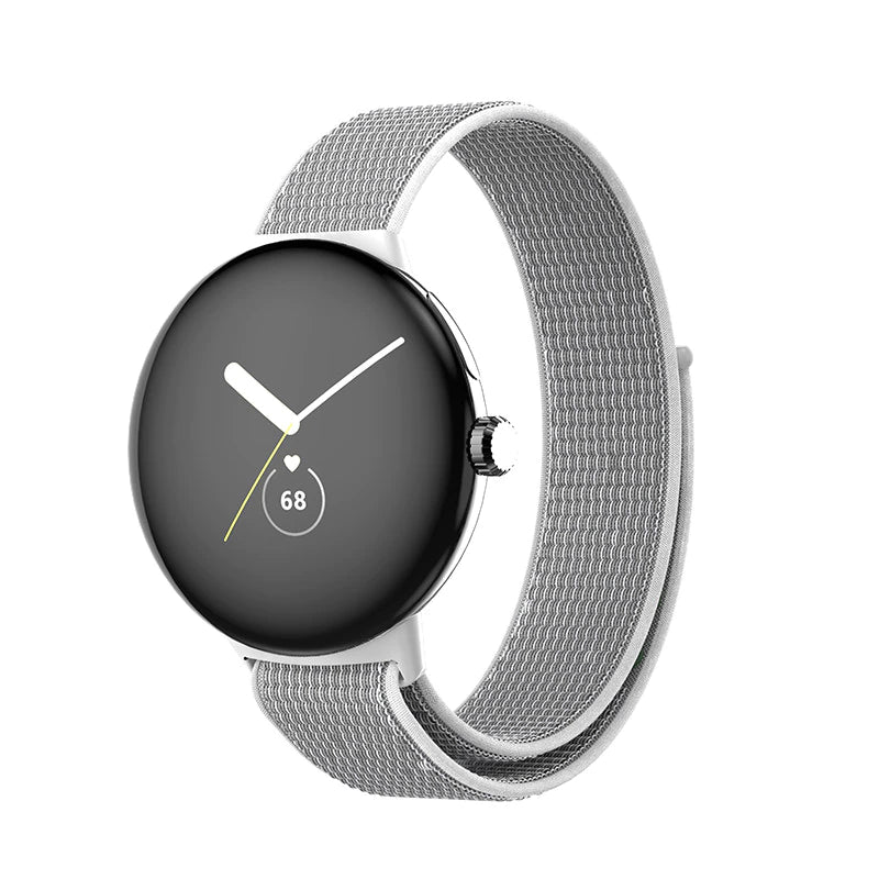Google Pixel Watch with silver mesh sport loop band displaying time and heart rate on black AMOLED screen