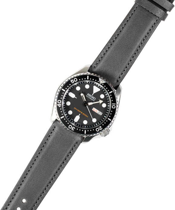 Black dive watch with stainless steel case on quick release padded leather strap