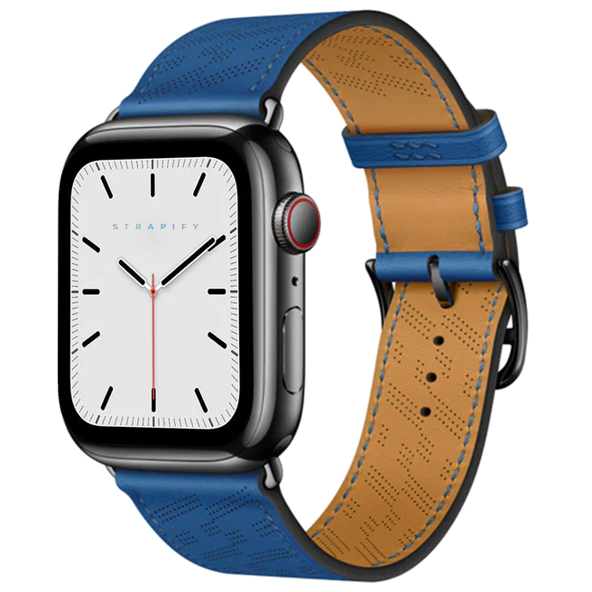 Black smartwatch with white dial and blue perforated leather single tour band, tan inner lining visible