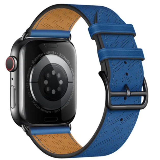 Apple Watch Series 8 with blue perforated leather single tour band and tan suede interior, stainless steel case
