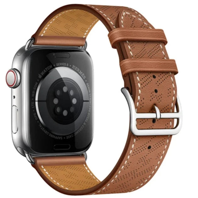 Silver stainless steel smartwatch with perforated tan brown leather band and white stitching single tour strap