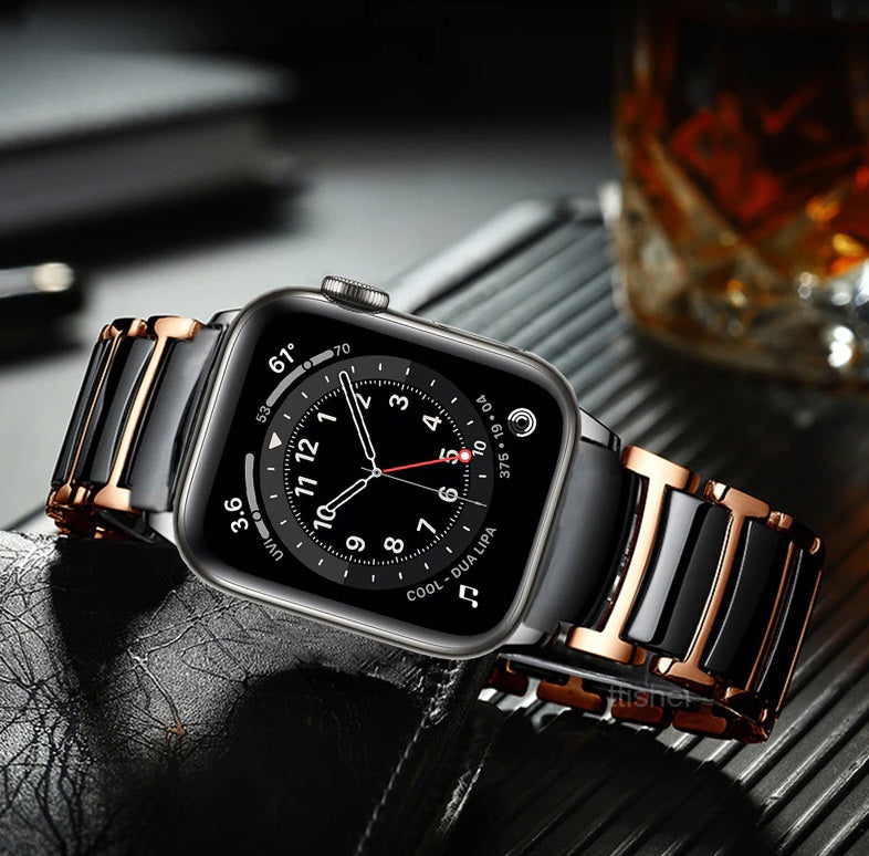 Black ceramic smartwatch with rose gold and silver dual-tone steel bracelet, analog dial display on dark textured surface