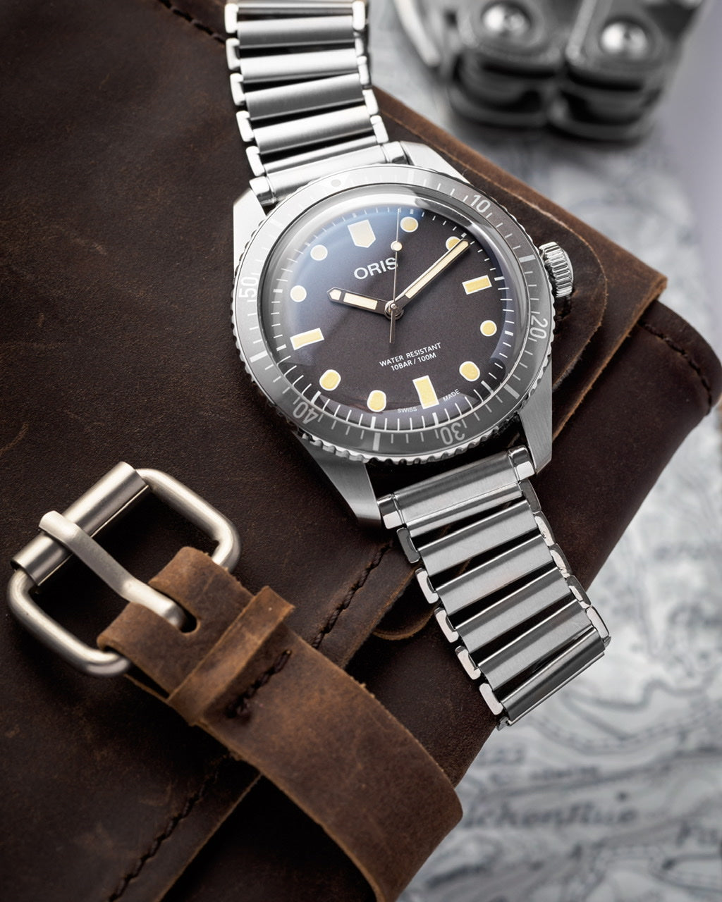 Oris dive watch with stainless steel bracelet and black dial on brown leather strap, water resistant timepiece