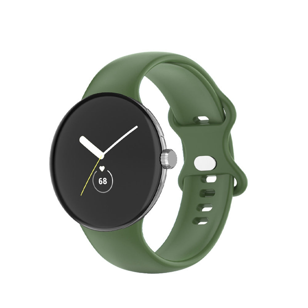 Google Pixel Watch with sage green silicone band and black minimalist dial with heart rate monitor