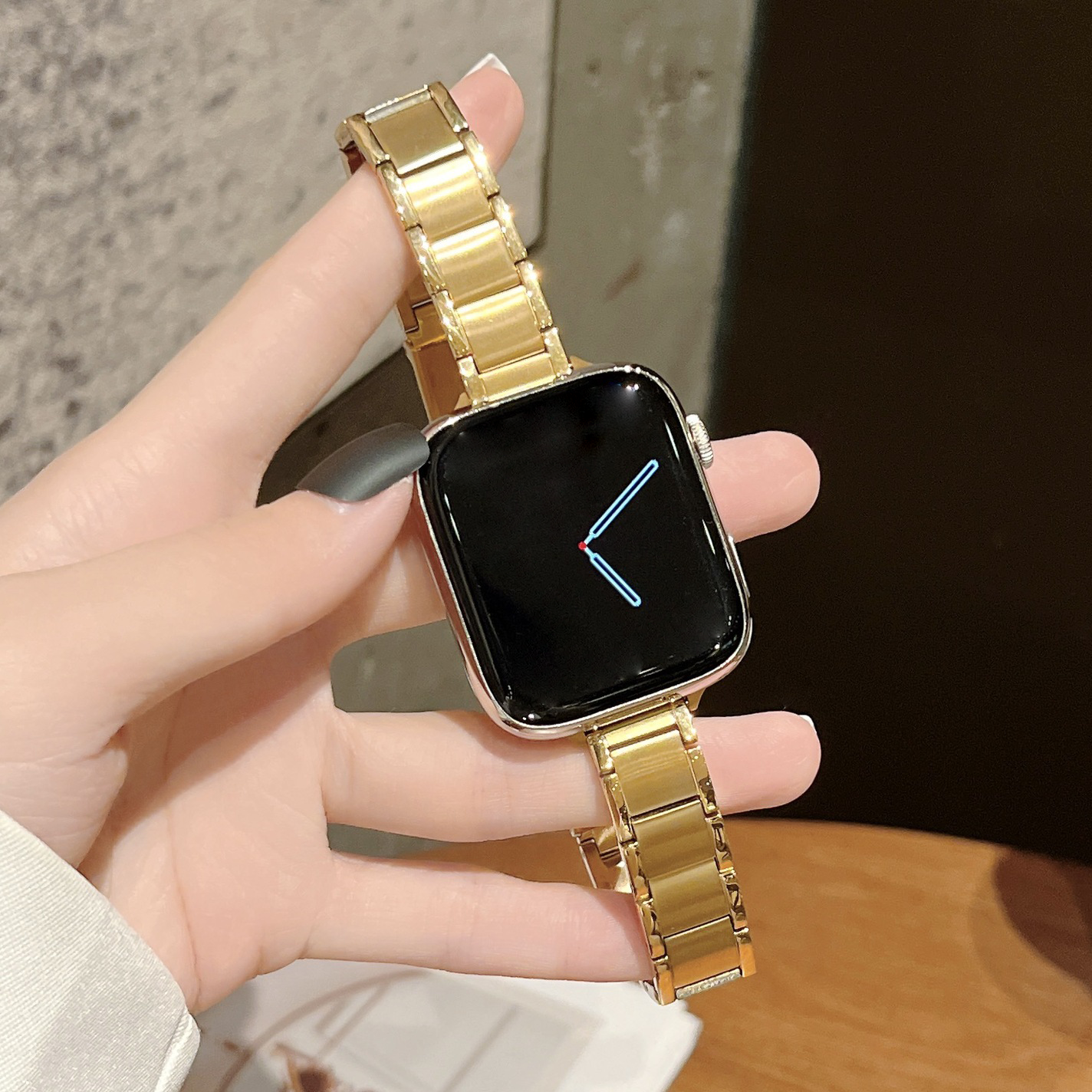 Gold stainless steel bracelet band for Apple Watch with square black smartwatch face display