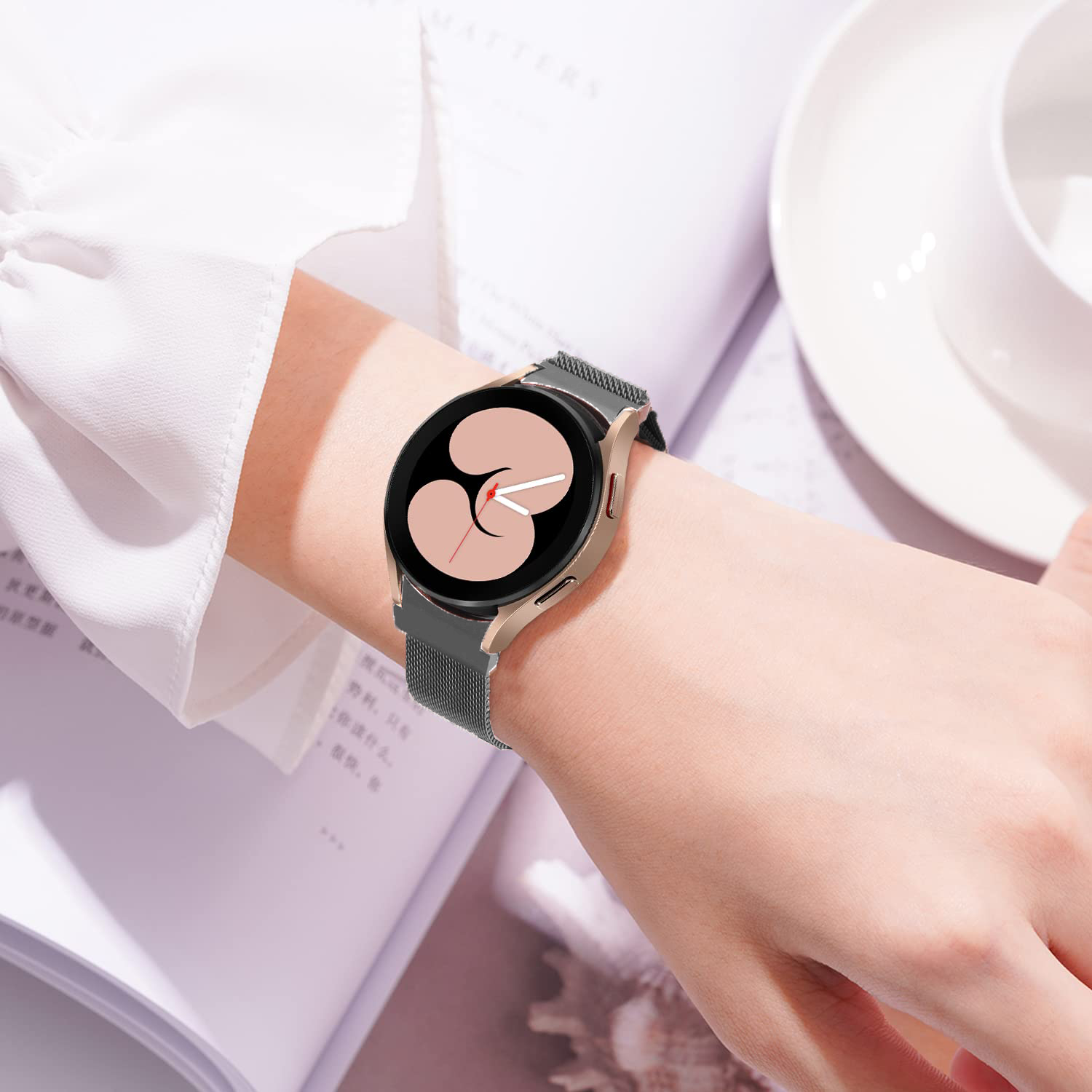 Galaxy Watch 4-7 Milanese band gunmetal grey on woman's wrist with minimalist watch face display