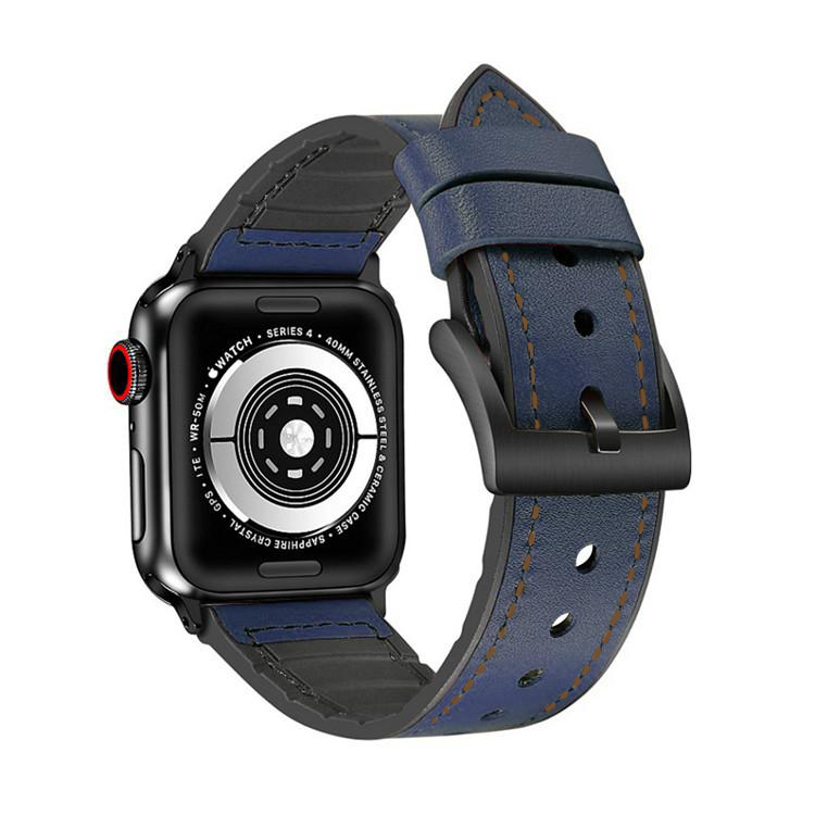 Black Apple Watch Series 4 with navy blue leather hybrid band featuring brown stitching and black silicone accents