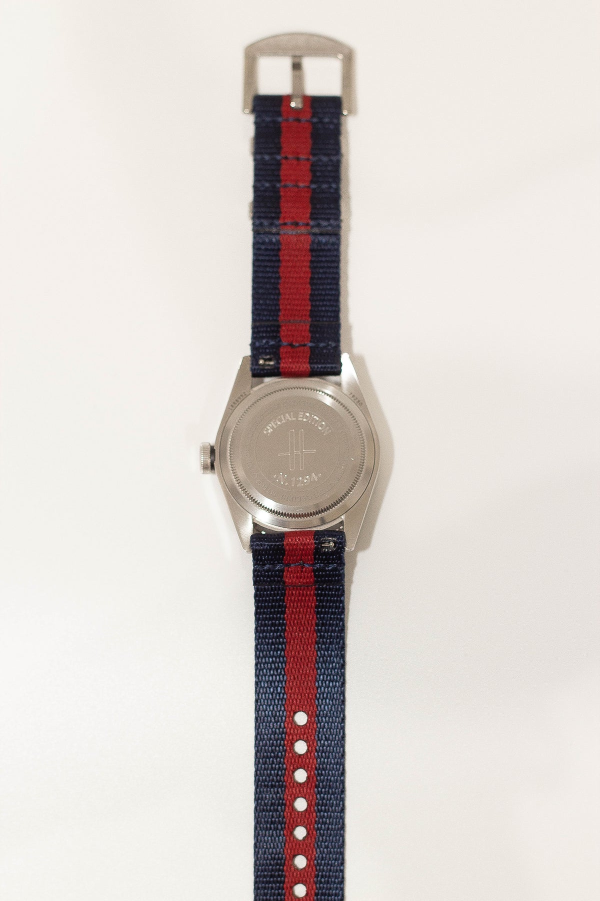 Stainless steel military watch with blue and red striped fabric strap and quick release buckle
