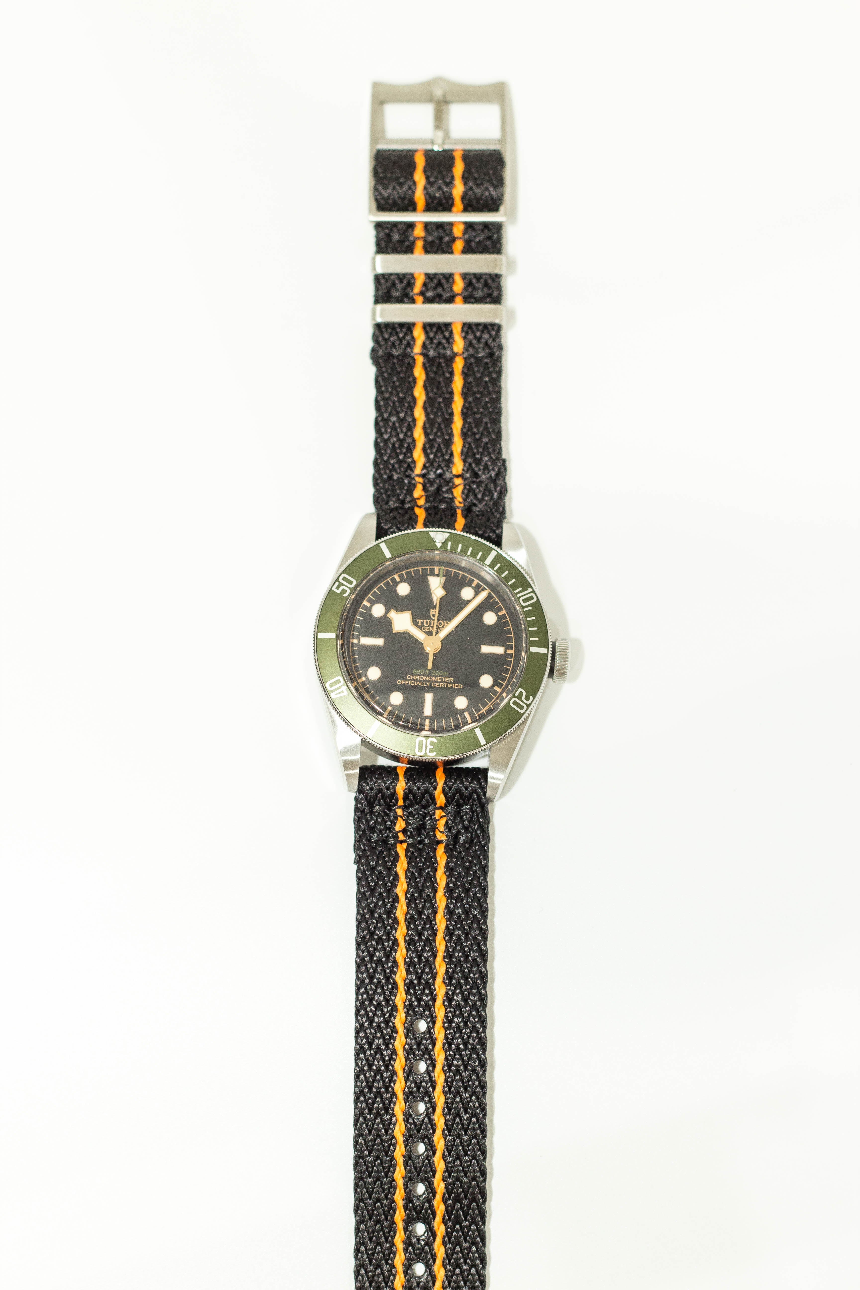 Black and orange Militex fabric watch strap with quick release pins, green bezel dive watch, stainless steel case
