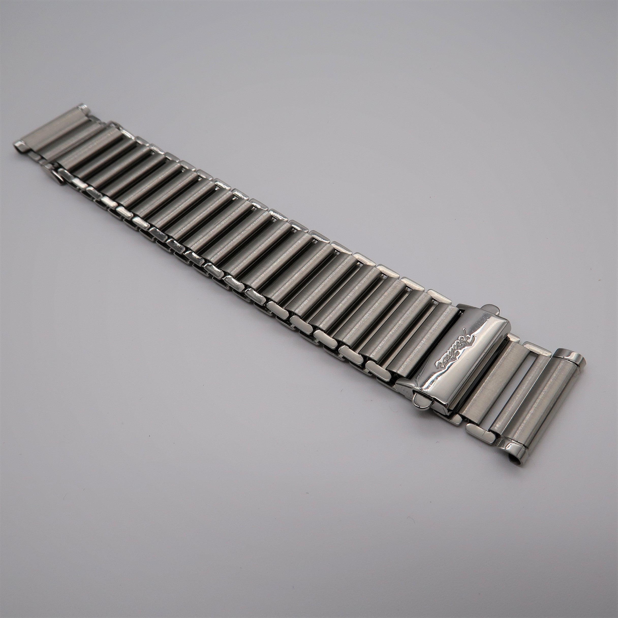 Stainless steel ladder-style watch bracelet with polished cylindrical links and secure clasp closure