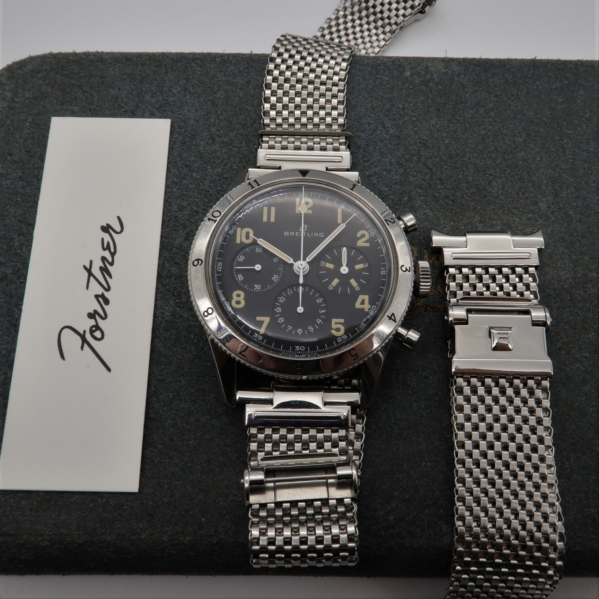 Breitling chronograph watch with stainless steel mesh bracelet and extra wide Horned ends mesh band on display mat