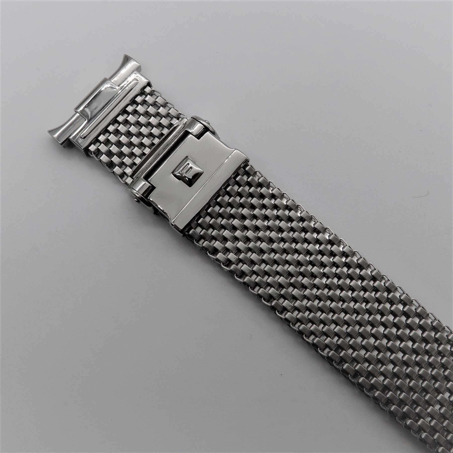 Stainless steel mesh watch bracelet with polished horned lugs and deployment clasp closure