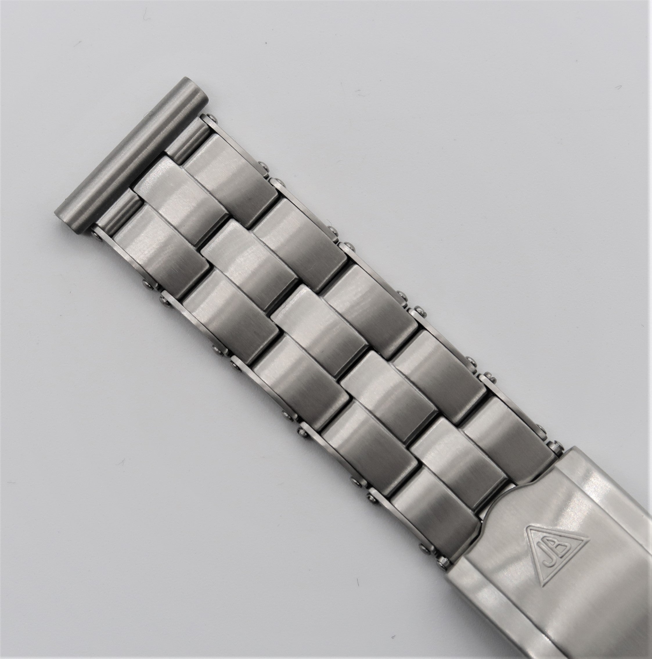 Stainless steel rivet bracelet with cylindrical link design and adjustable stretch band closure