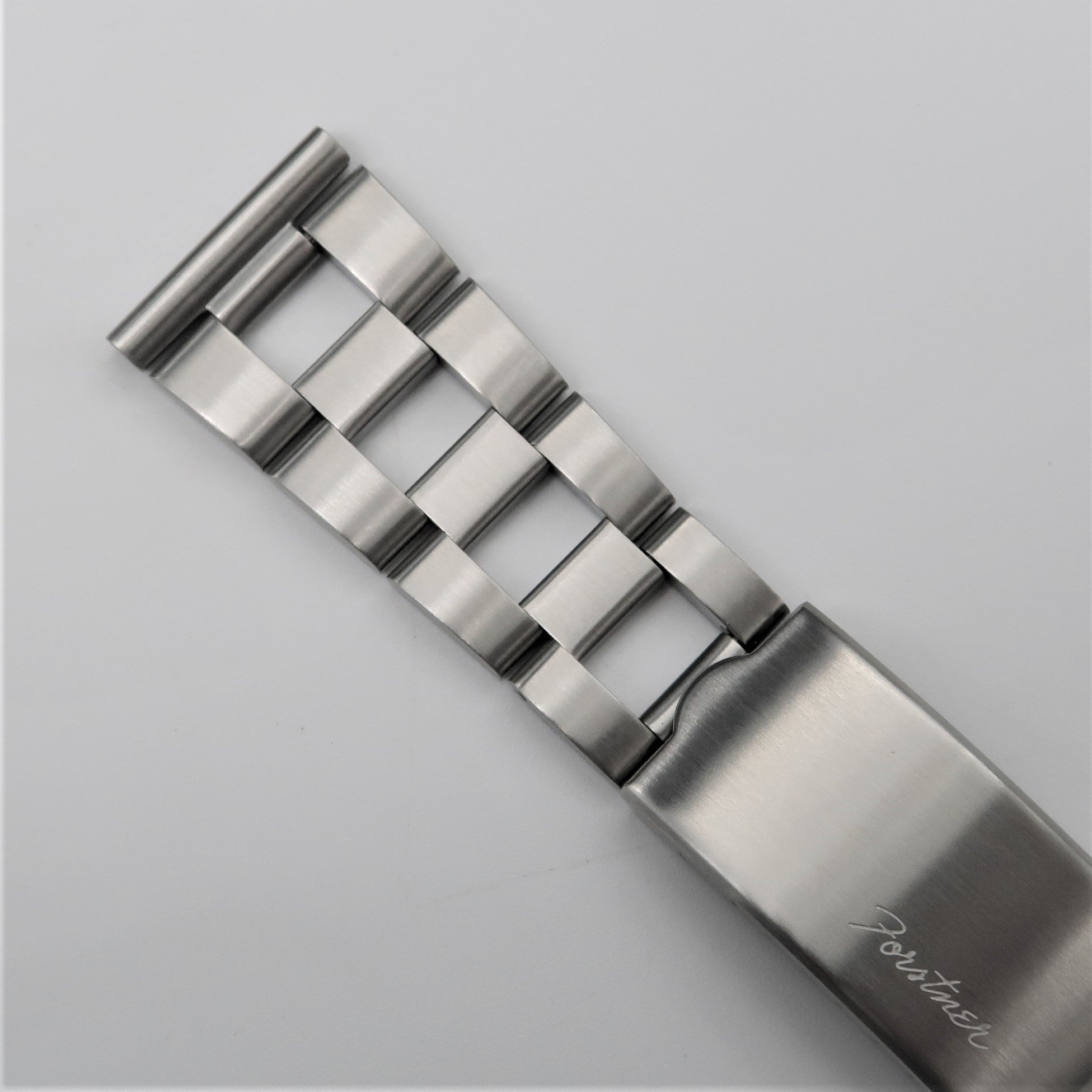 Stainless steel ladder bracelet with polished finish and adjustable links on gray background