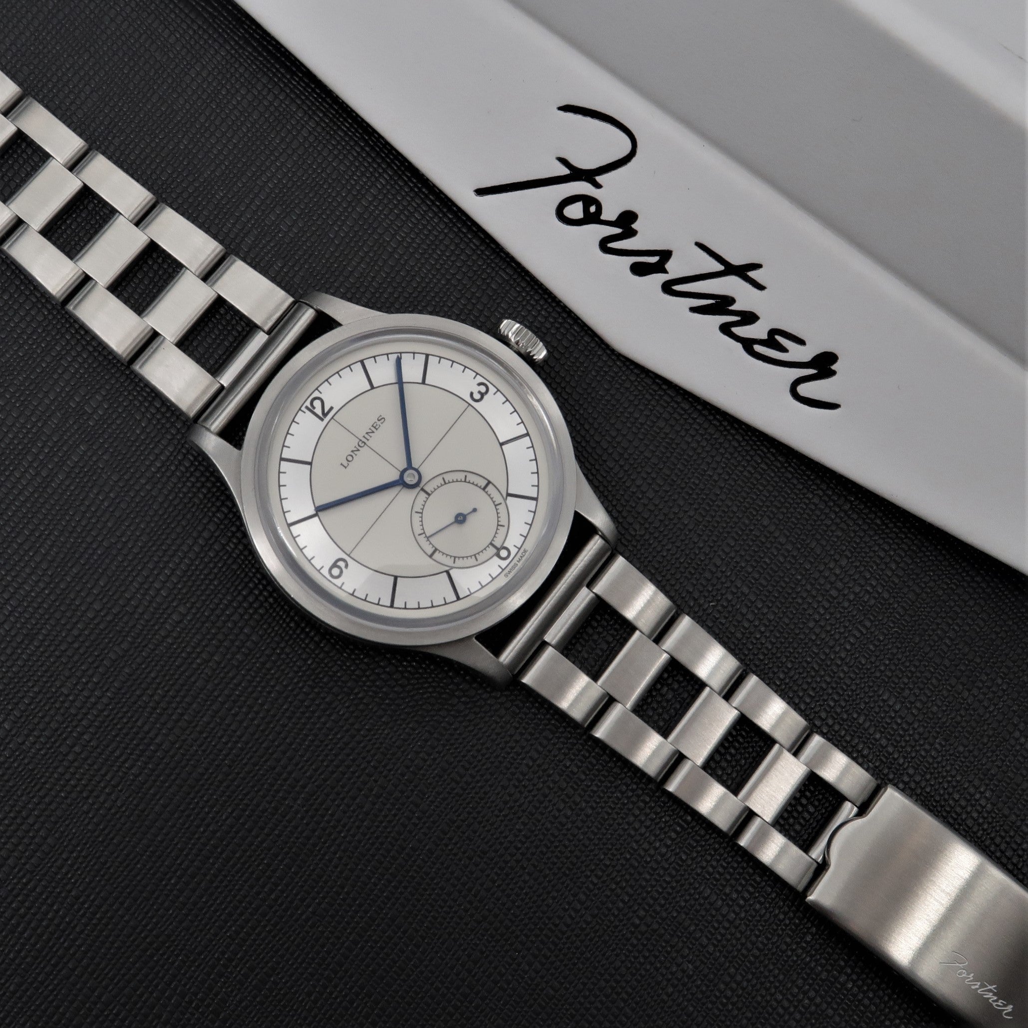 Forstner Ladder Bracelet stainless steel watch with cream dial and blue hands on black background