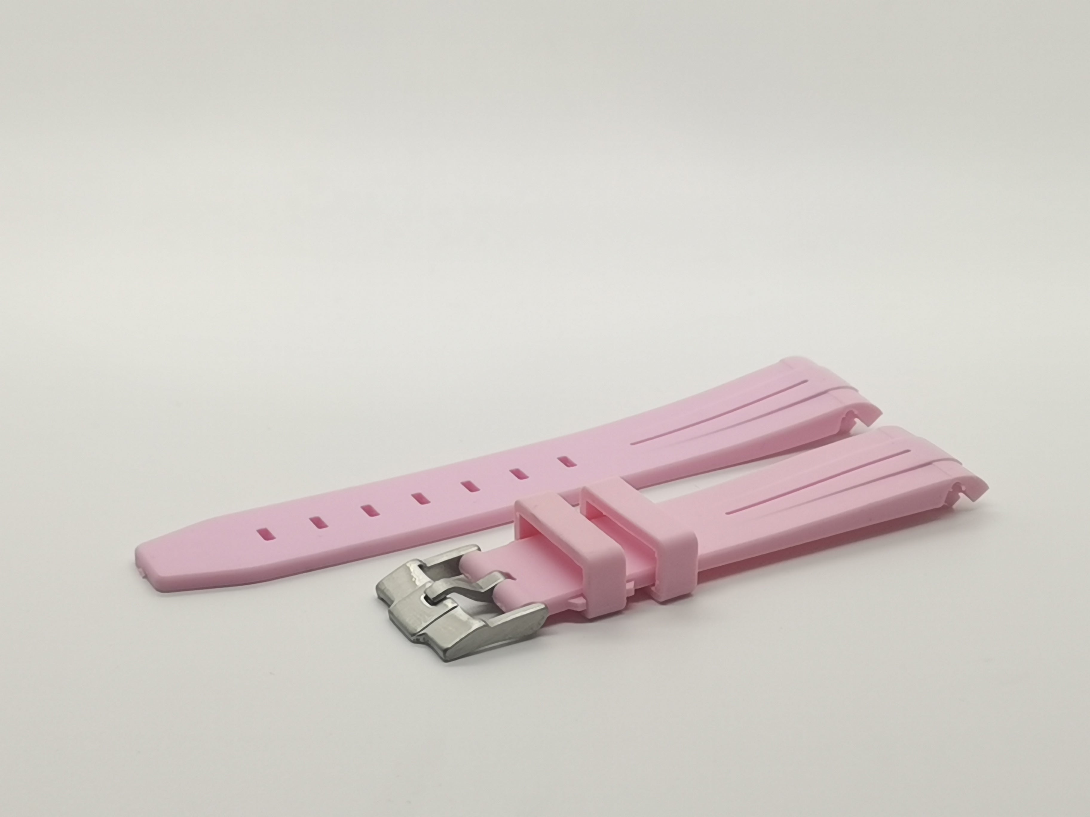 Pink curved rubber watch band with metal buckle and adjustable slots