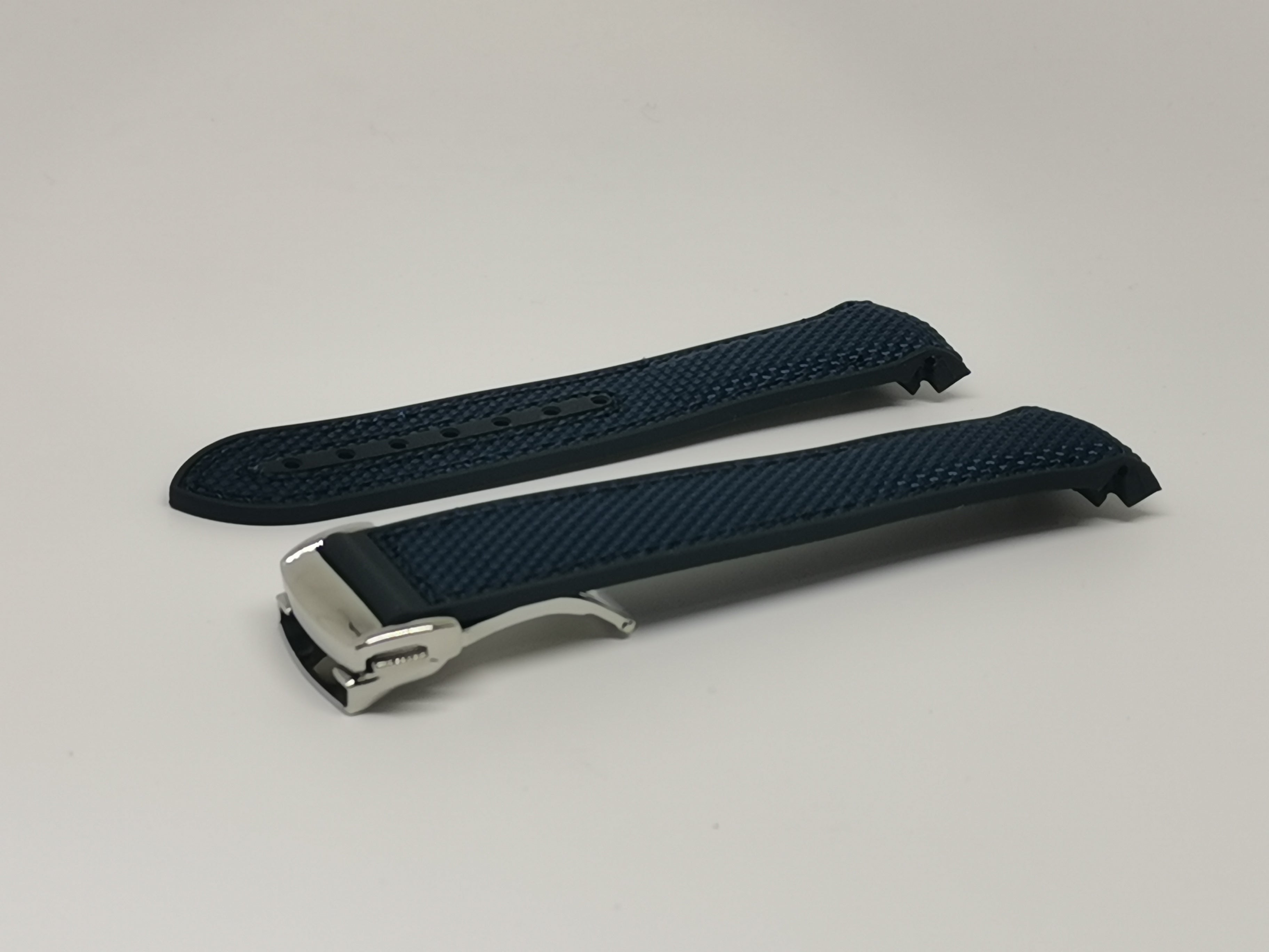 Navy blue hybrid rubber watch strap with curved design and deployant clasp, shown open and closed views