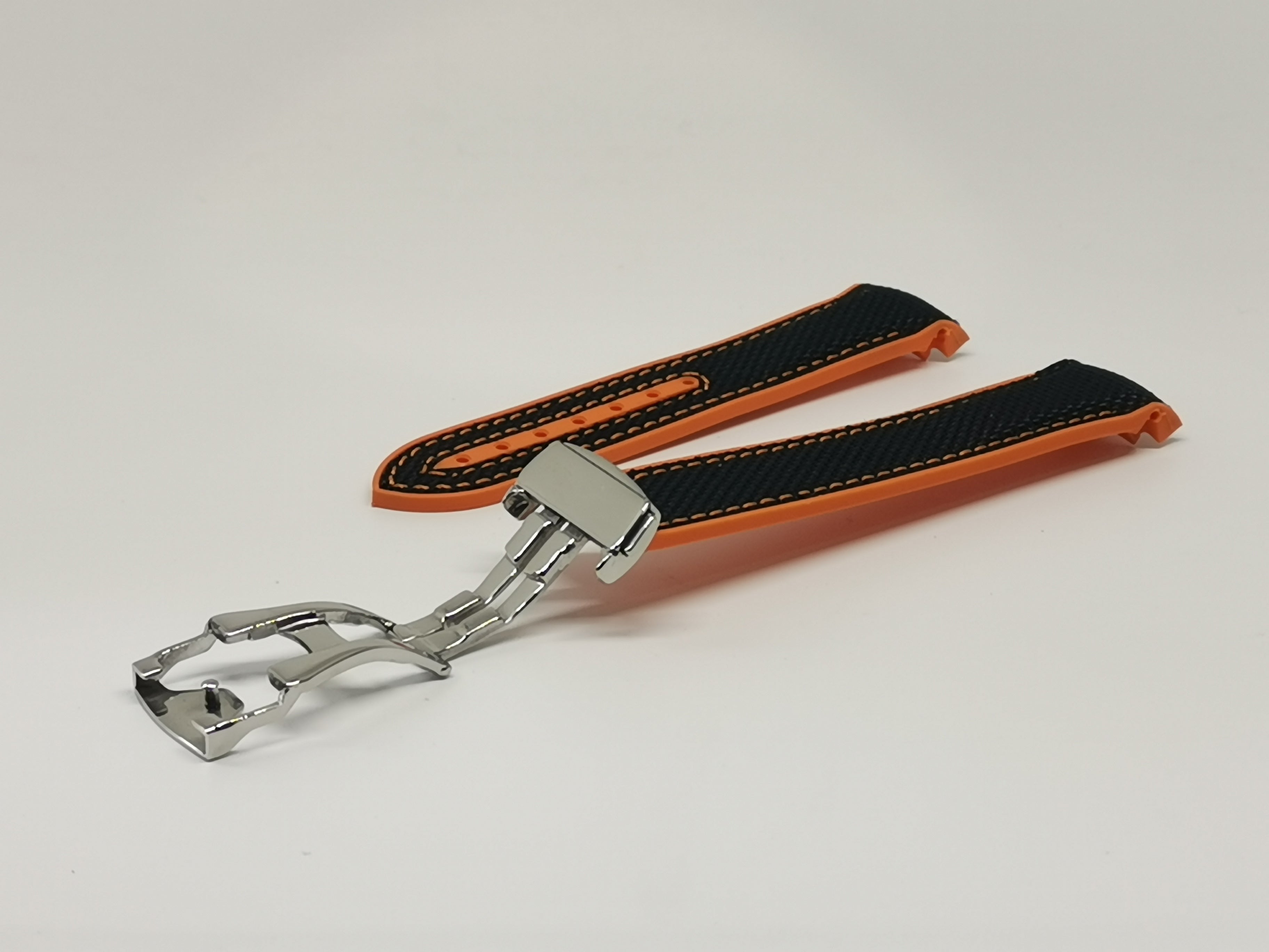 Curved King Hybrid Rubber watch strap in black and orange with stainless steel deployant clasp