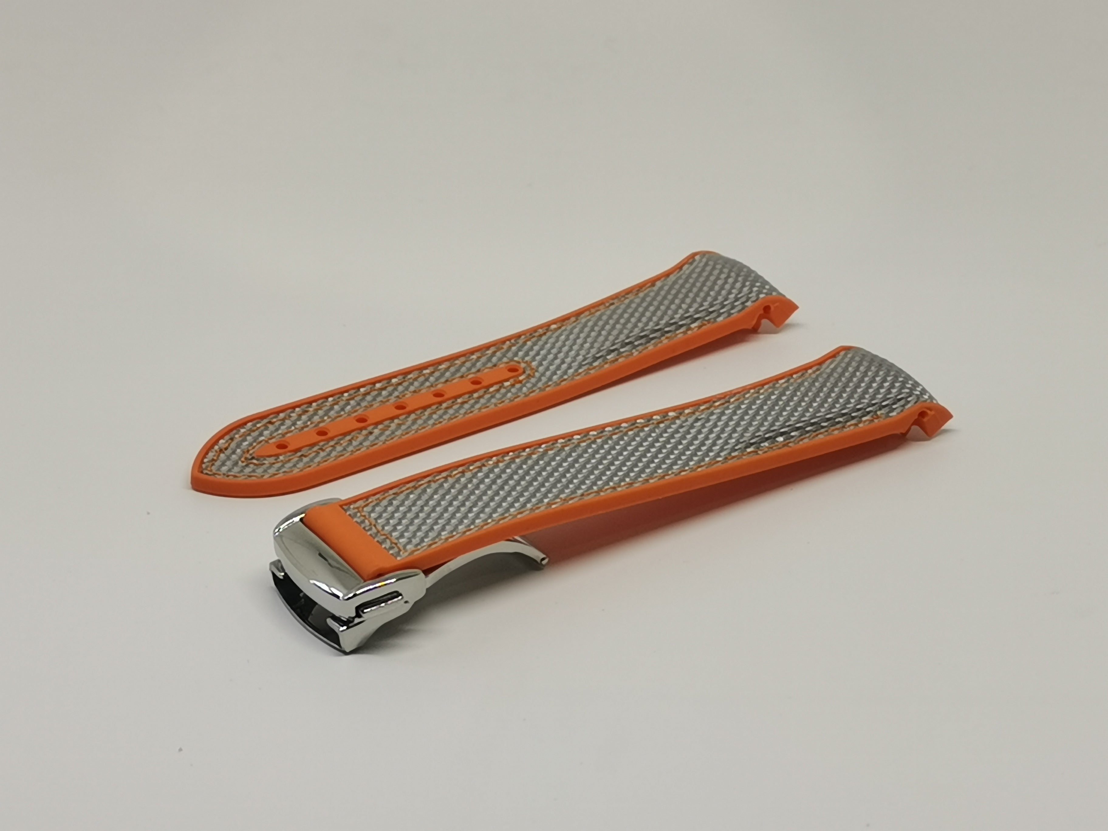 Curved King Hybrid Rubber watch strap in silver grey with orange trim and polished silver deployant clasp