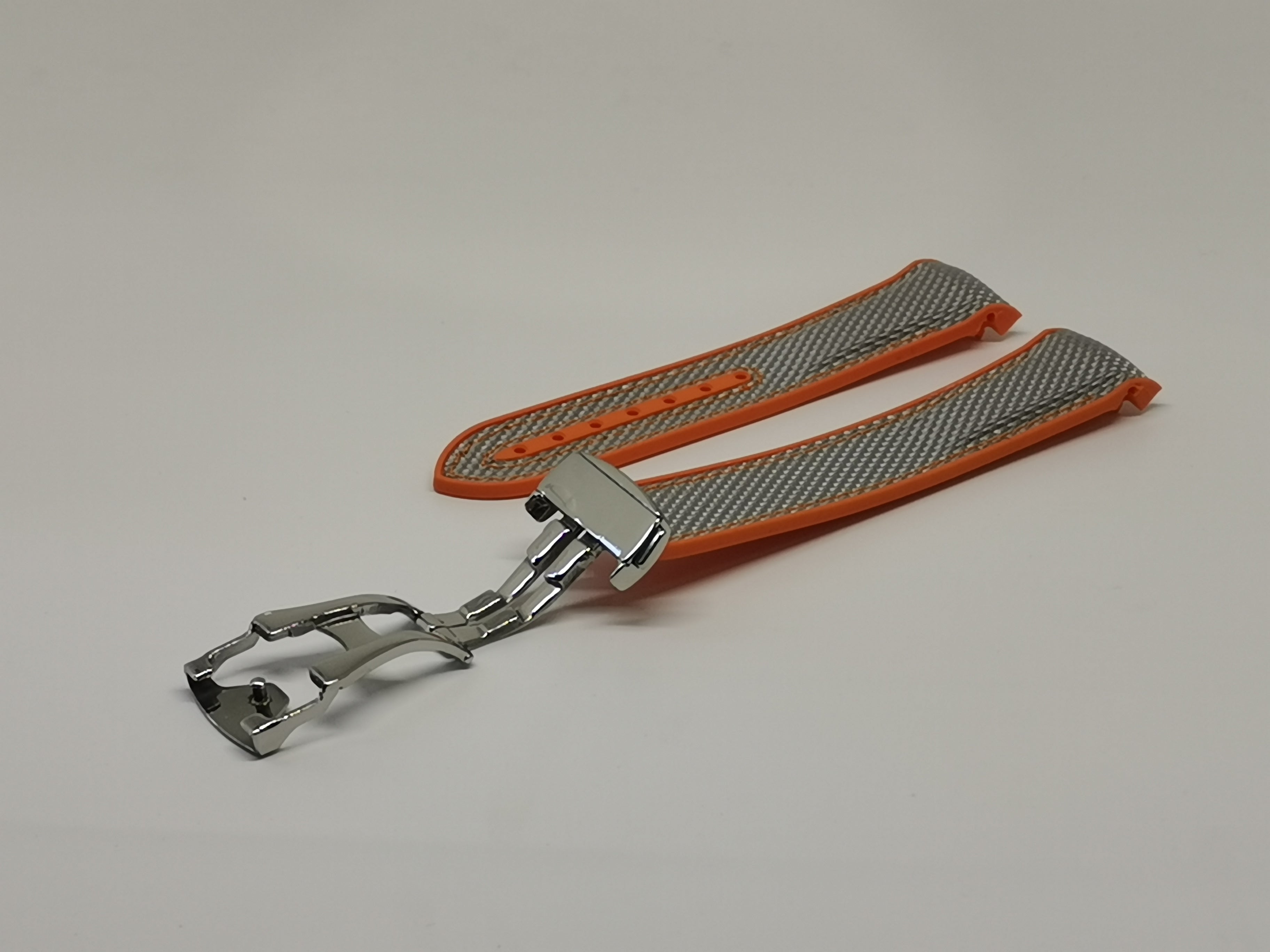 Orange hybrid rubber watch strap with gray textile detail and silver deployant clasp