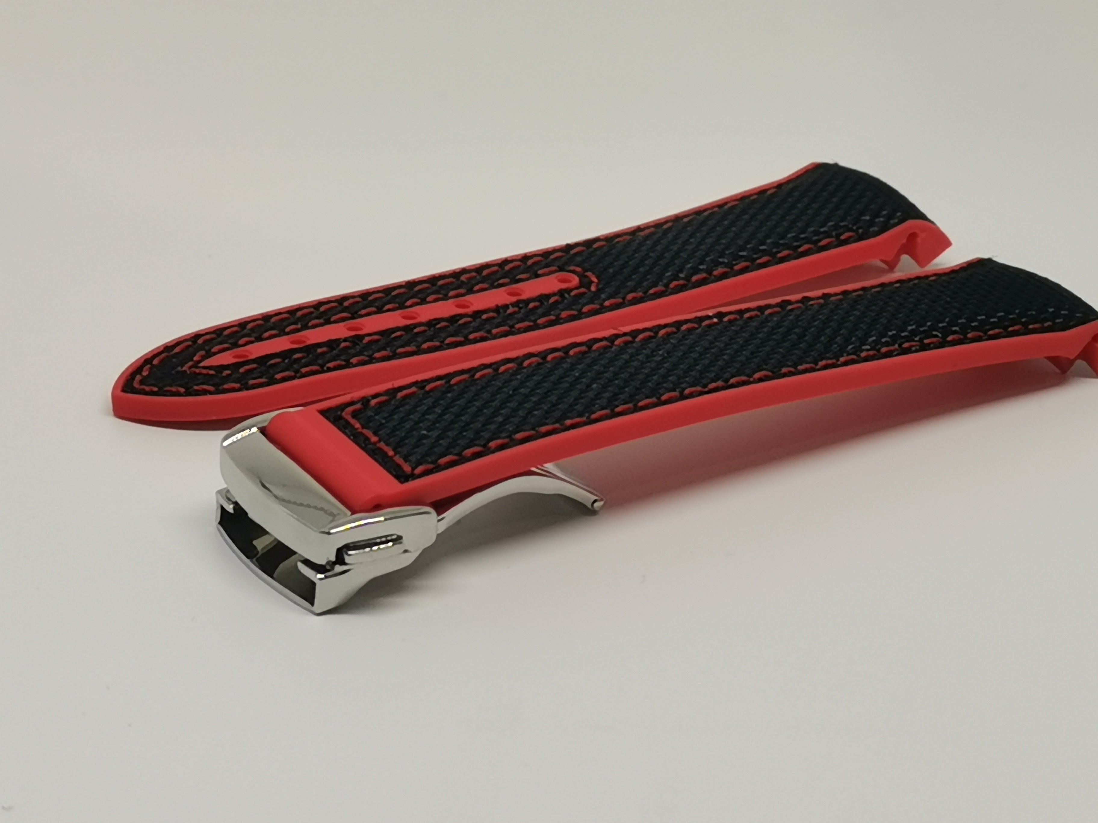 Red and black hybrid rubber watch strap with deployant clasp, curved design for optimal wrist fit