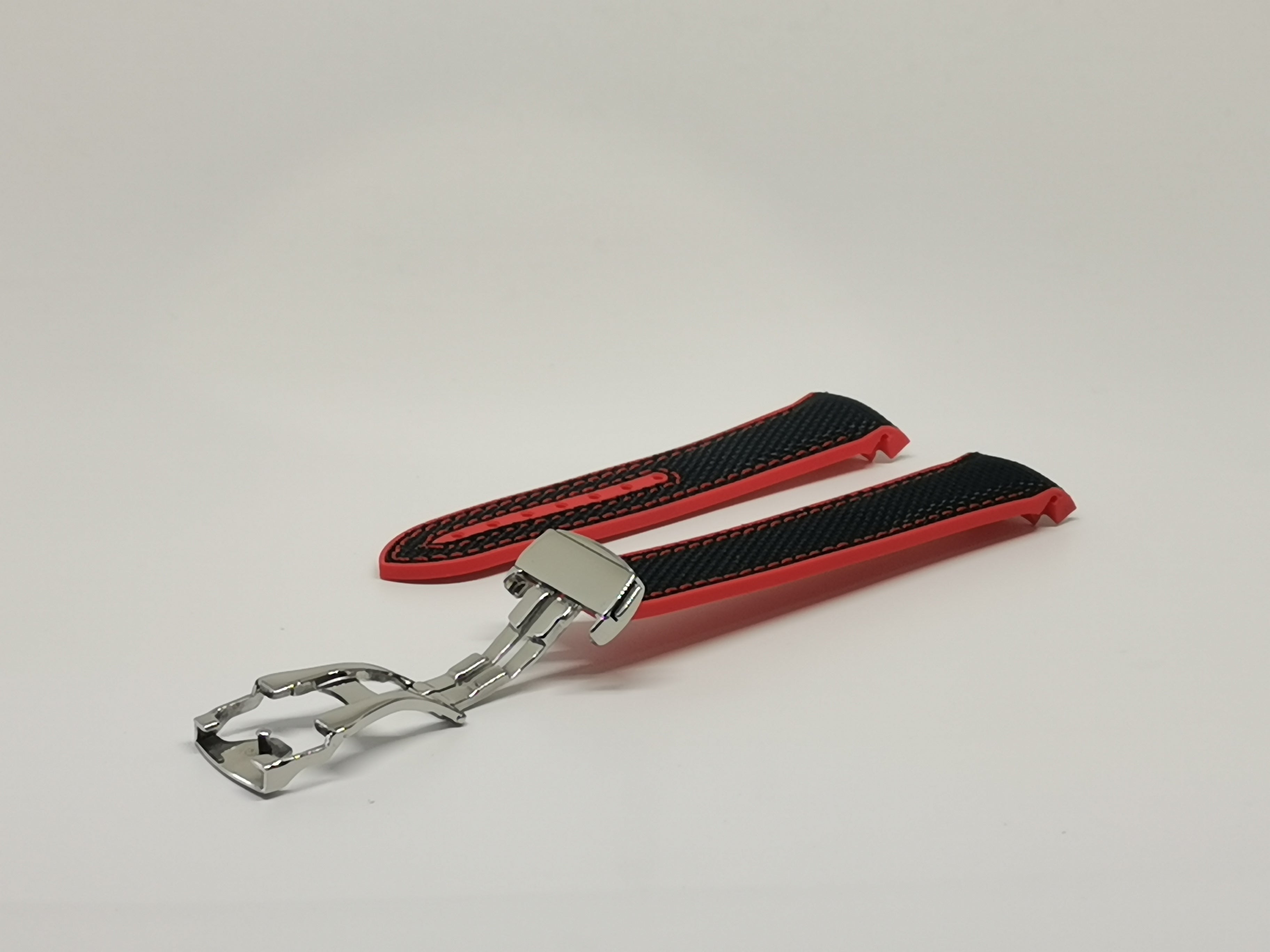 Red and black hybrid rubber curved watch band with stainless steel deployant clasp