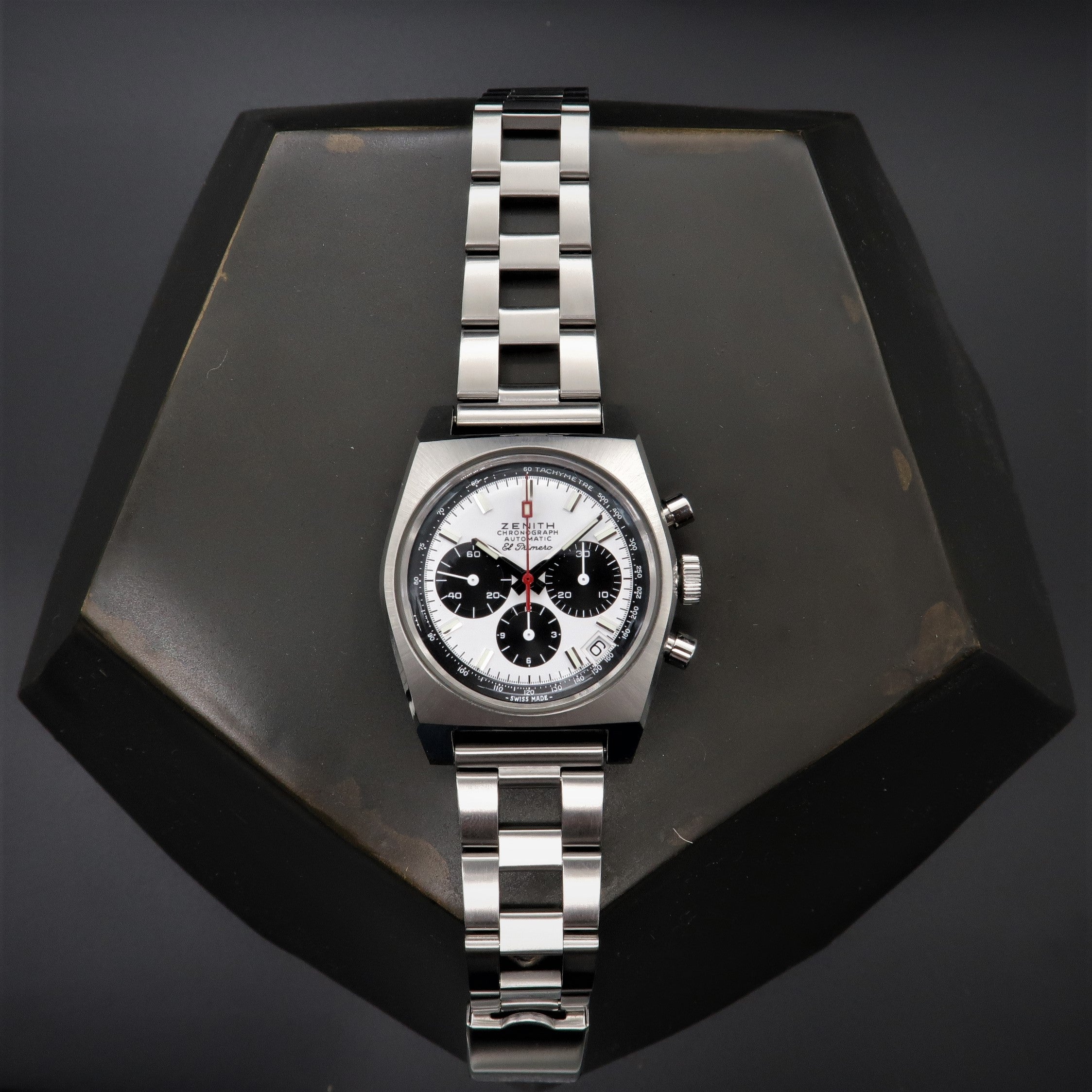 Zenith vintage chronograph watch with silver and black dial, three subdials, and stainless steel bracelet on display stand
