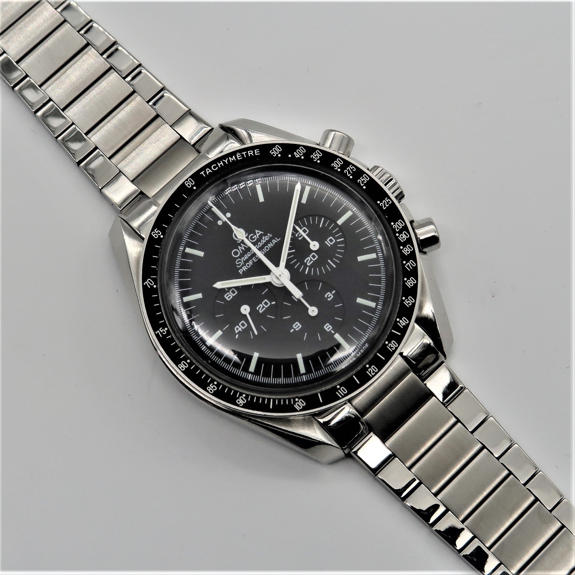 Stainless steel flat link bracelet for Omega Speedmaster chronograph watch with polished metal links and secure clasp