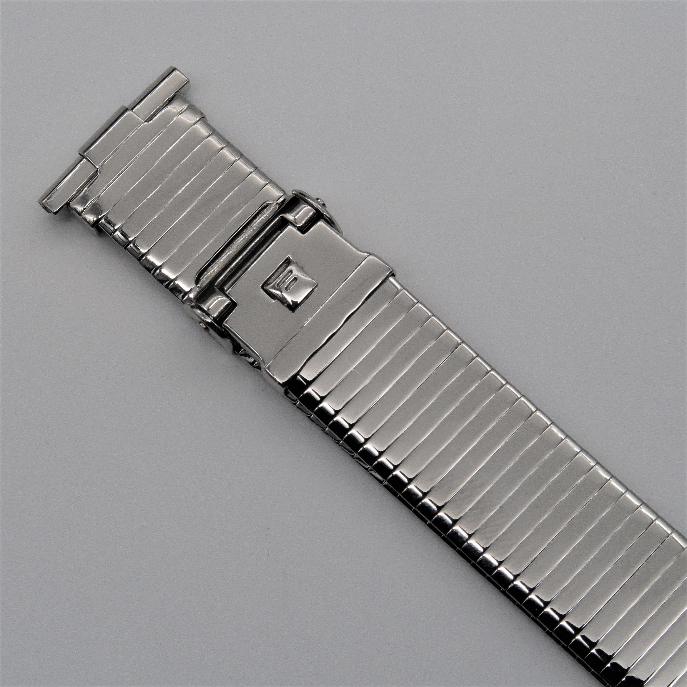 Stainless steel expansion watch band with military-style clasp and thin profile design