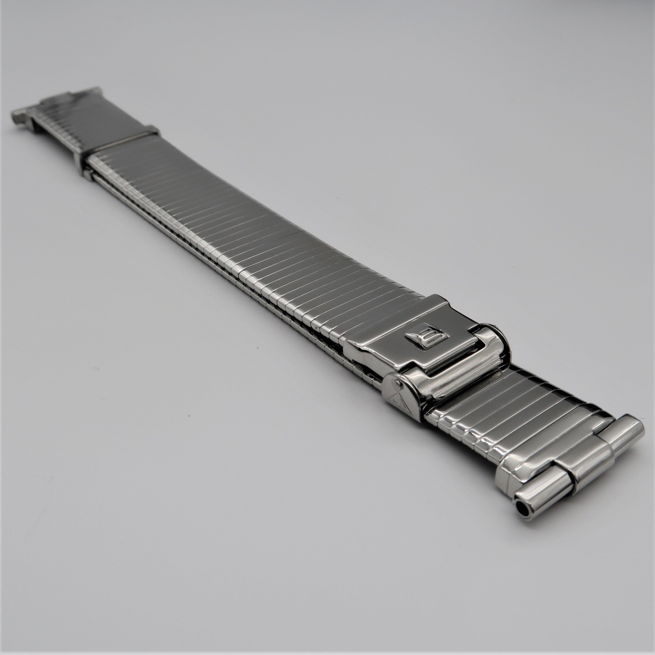 Stainless steel metal watch band with deployment clasp and ribbed links for military-style timepiece