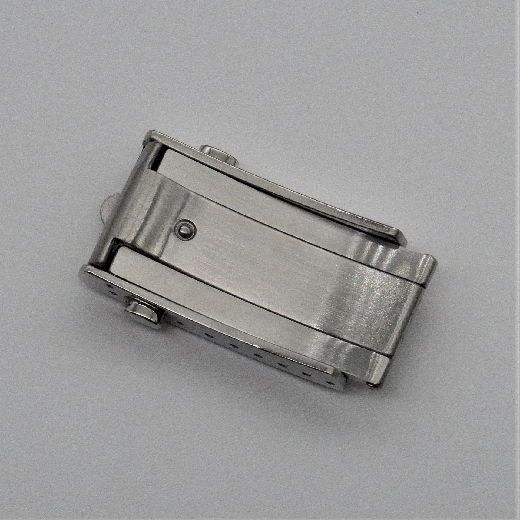 Brushed stainless steel push-button military belt buckle with milled clasp mechanism and adjustment holes