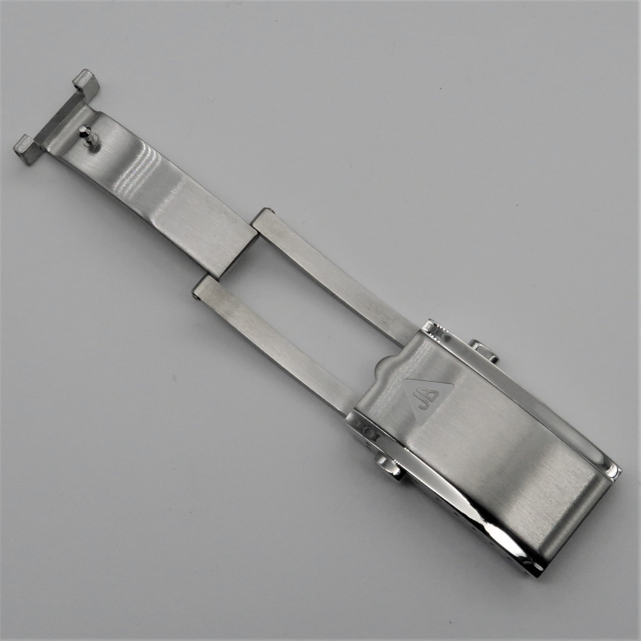 Stainless steel push-button milled clasp with hexagonal fasteners and threaded shaft components on gray background
