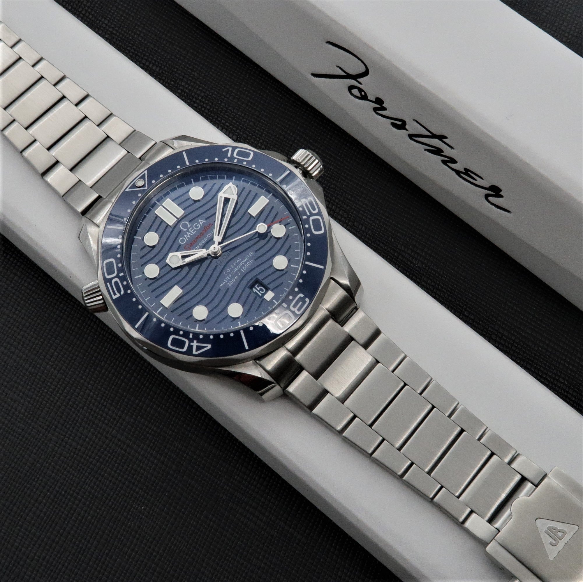 Omega Seamaster dive watch with blue dial and stainless steel bracelet on white presentation box