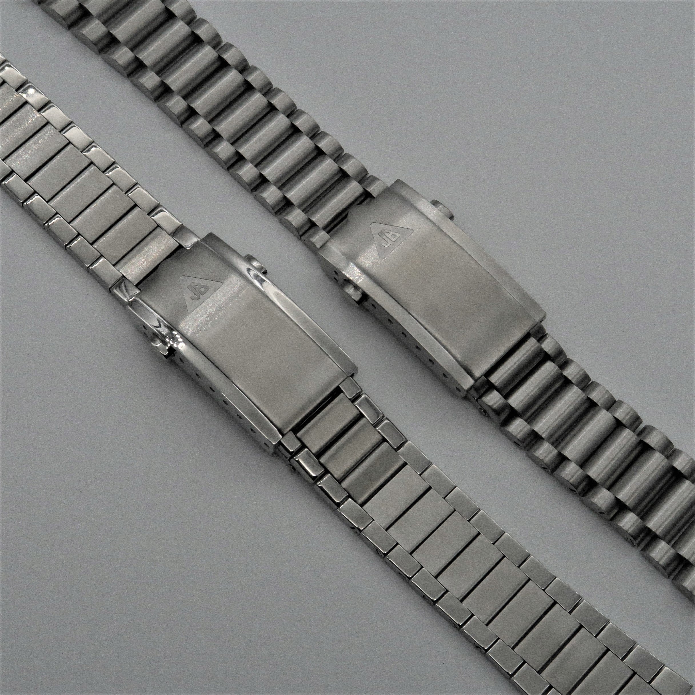 Stainless steel watch bracelets with push-button milled clasp closures shown side by side