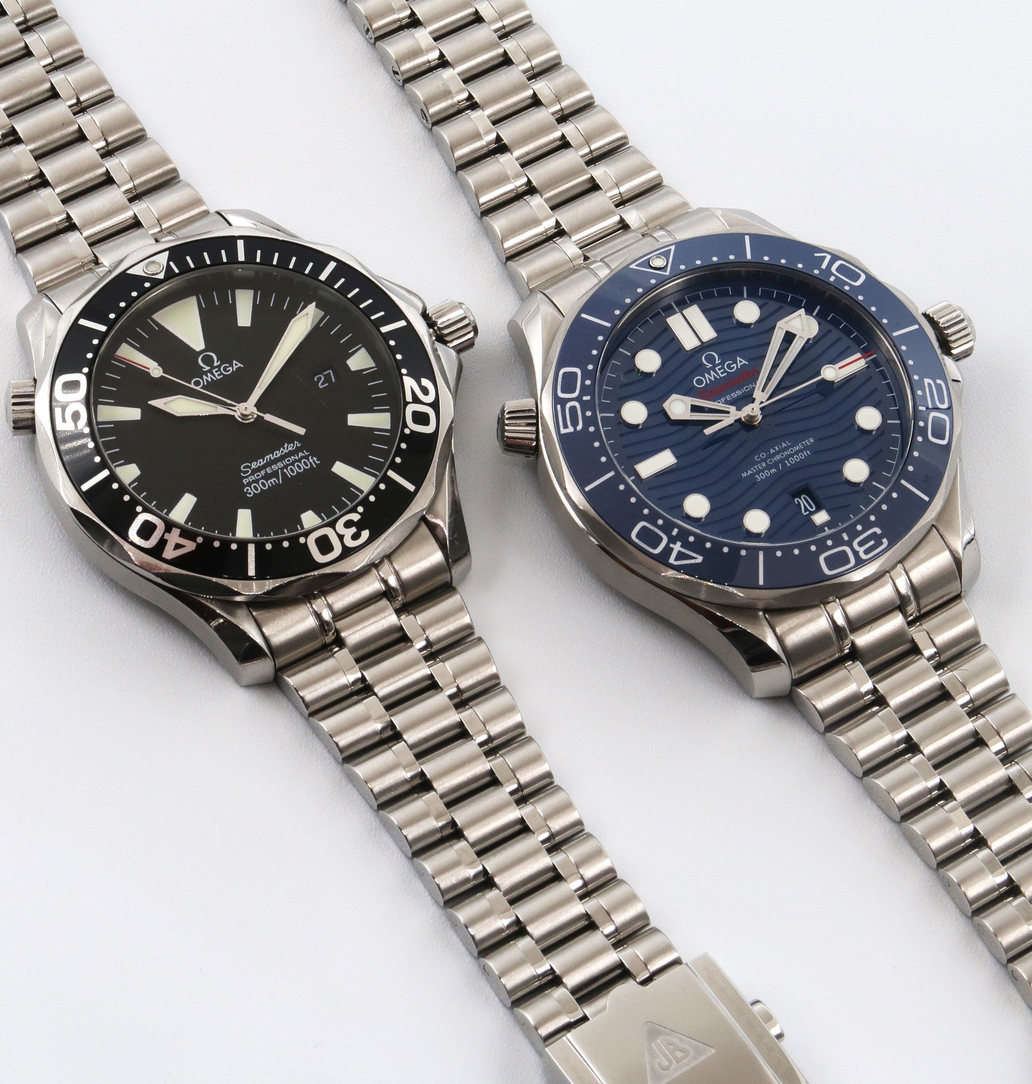 Two Omega Seamaster Professional 300M dive watches with stainless steel Bullet bracelets, black and blue dials
