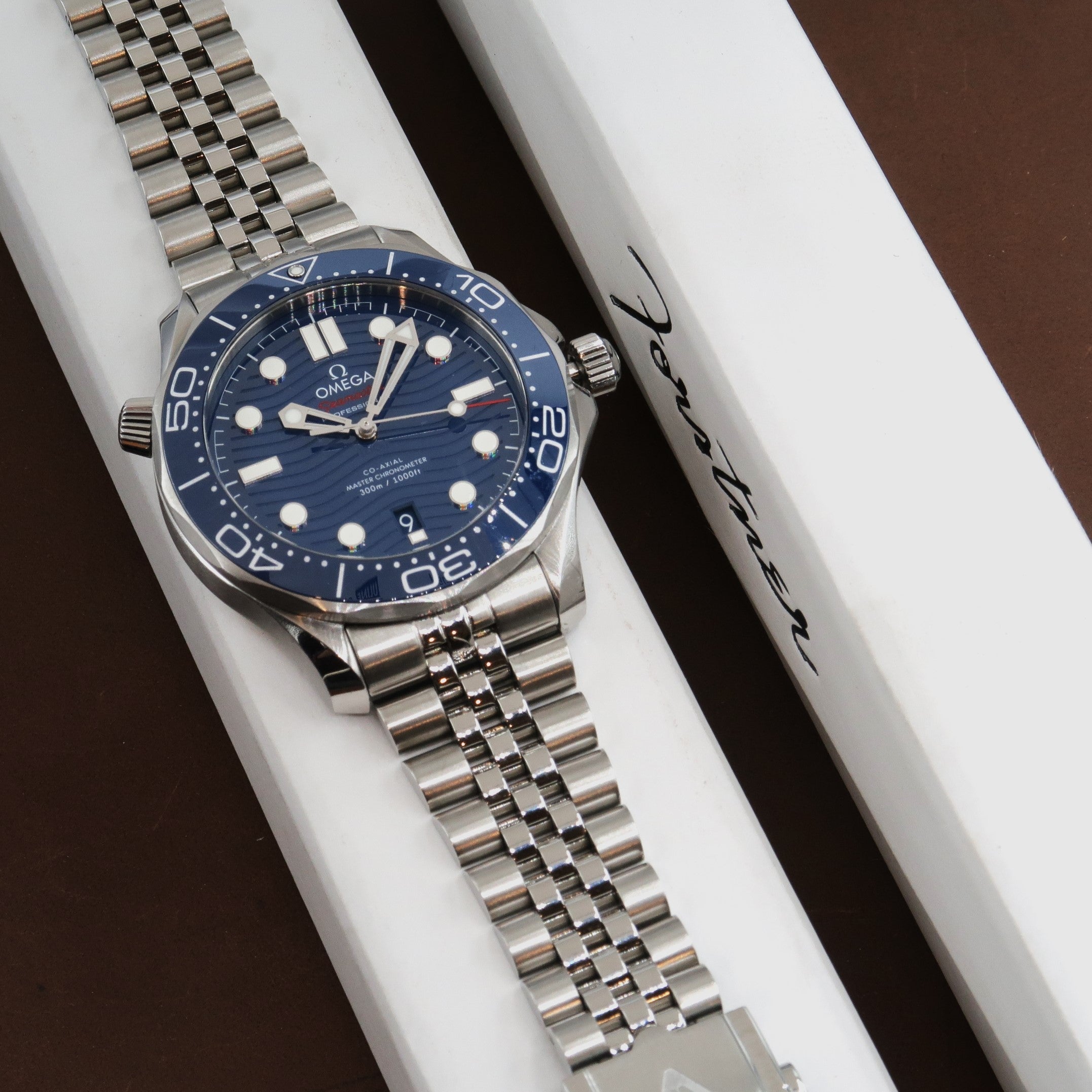 Omega Seamaster Professional 300M stainless steel dive watch with blue dial and bracelet on white display box