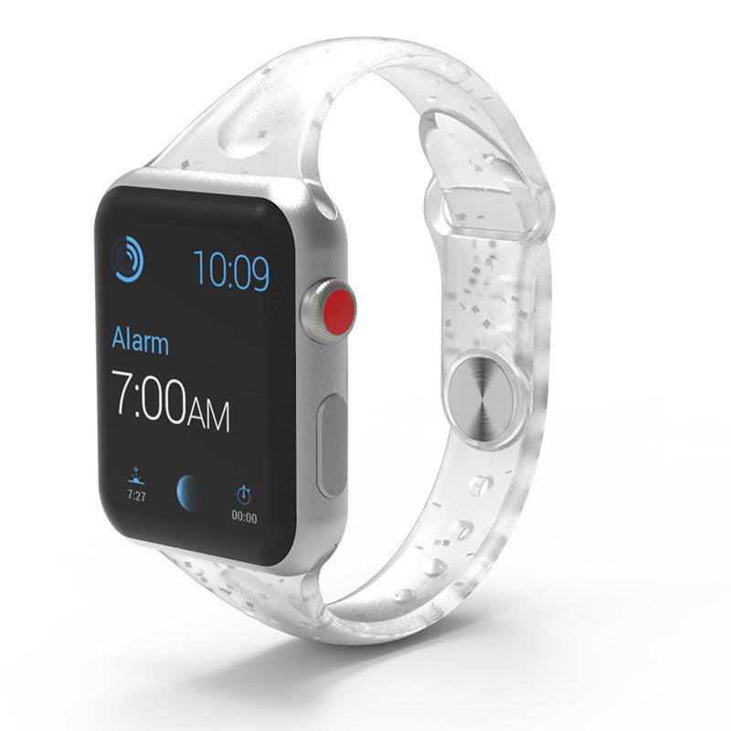 Clear translucent smartwatch band with silver aluminum case and red digital crown button displaying time and alarm notification