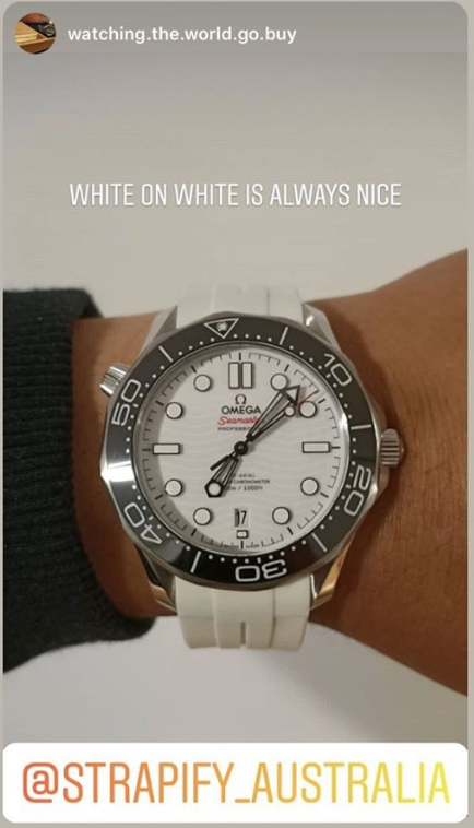 Omega Seamaster white dial watch with black bezel and white rubber strap on wrist